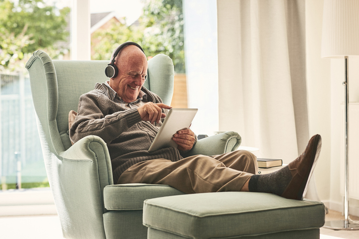 man enjoying his hearing aids while reading